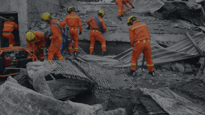 A search and rescue team standing on top of a building.